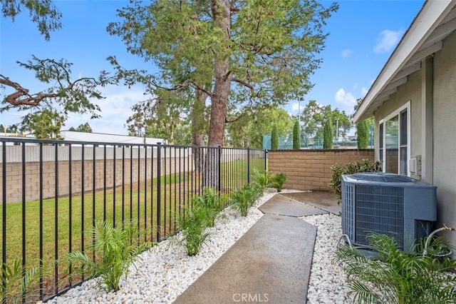 view of yard with central AC and a patio