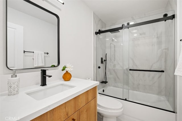 full bathroom with toilet, vanity, and bath / shower combo with glass door