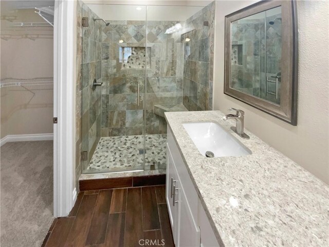 bathroom featuring vanity and an enclosed shower