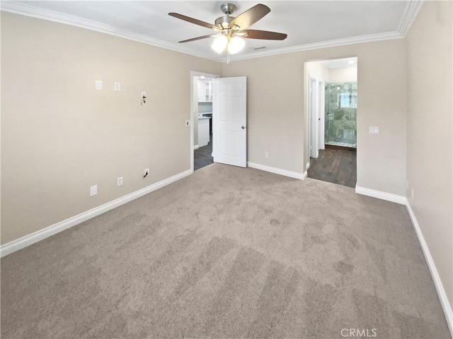 spare room with crown molding, ceiling fan, and dark carpet