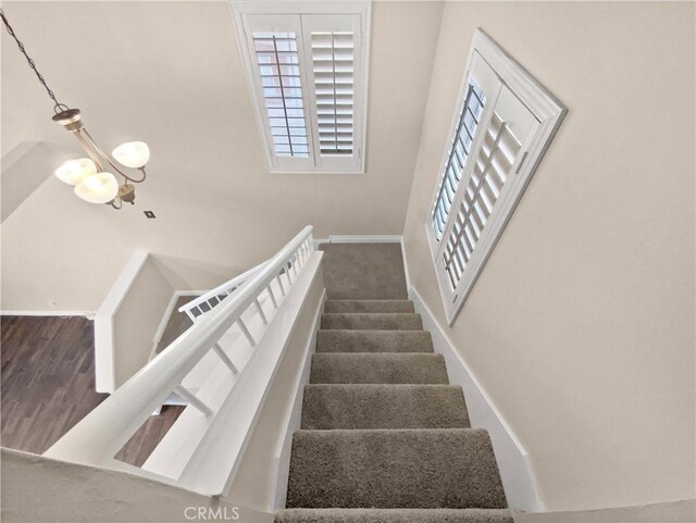 stairway with a chandelier