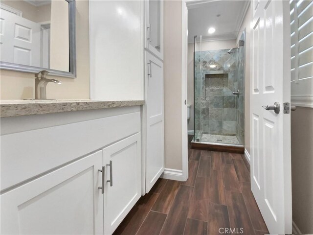 bathroom with ornamental molding and a shower with door