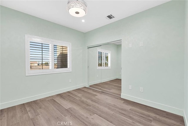 spare room with light wood-type flooring