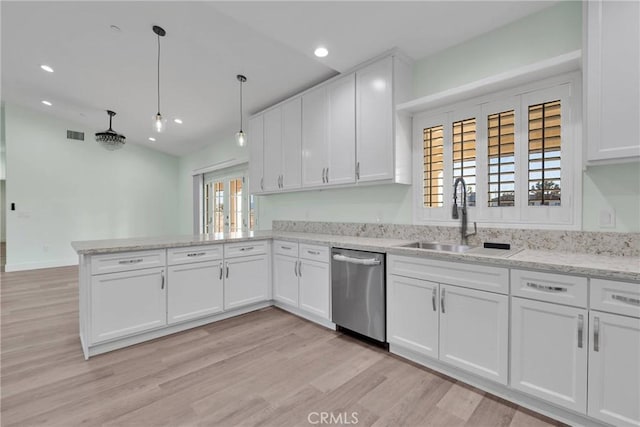 kitchen featuring sink, white cabinetry, decorative light fixtures, dishwasher, and kitchen peninsula