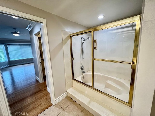 bathroom with tile patterned flooring, bath / shower combo with glass door, and ceiling fan