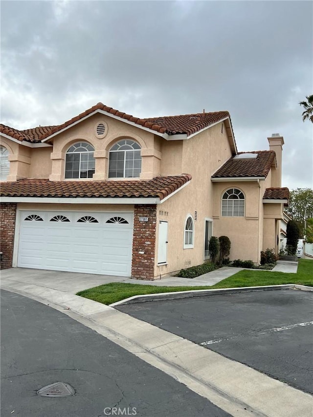 mediterranean / spanish-style house with a garage