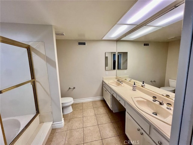 bathroom with vanity, toilet, a bathing tub, and tile patterned flooring