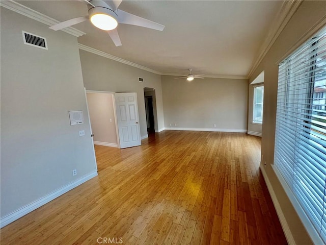 spare room featuring lofted ceiling, ornamental molding, light hardwood / wood-style floors, and ceiling fan