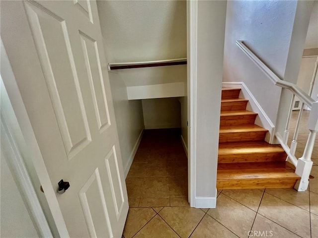 stairs with tile patterned floors