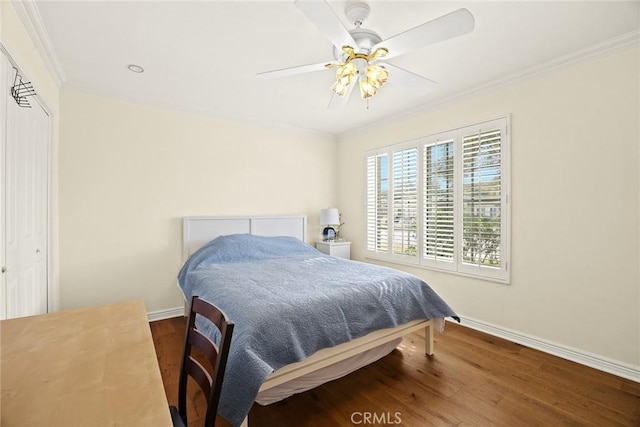 bedroom featuring ceiling fan, ornamental molding, and hardwood / wood-style floors