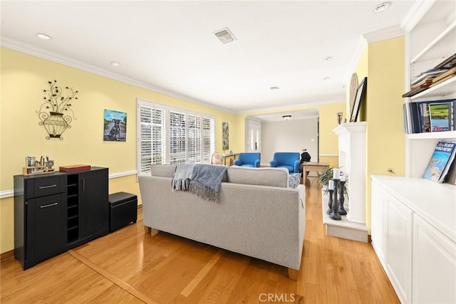 living room with crown molding and light wood-type flooring