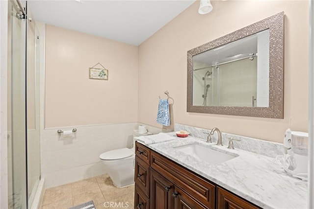 bathroom featuring tile patterned flooring, vanity, an enclosed shower, and toilet