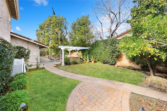 view of yard with a pergola and a patio area