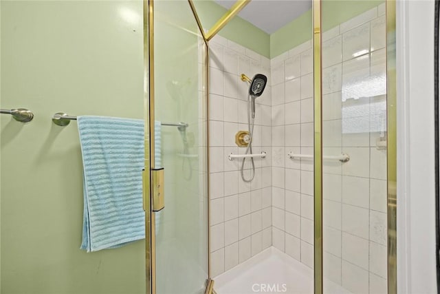 bathroom featuring a shower with door