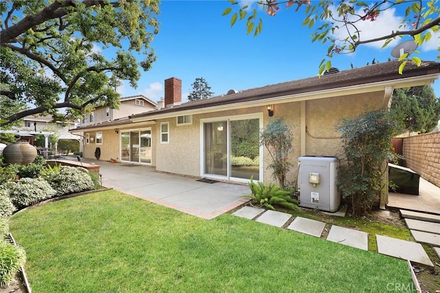 back of property with a patio and a yard