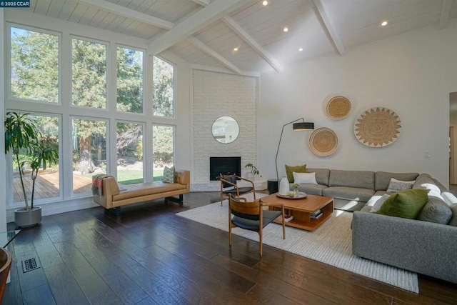 living room with dark hardwood / wood-style flooring, a fireplace, high vaulted ceiling, and beamed ceiling