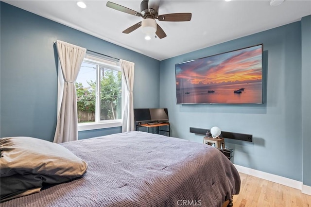 bedroom featuring light hardwood / wood-style flooring and ceiling fan