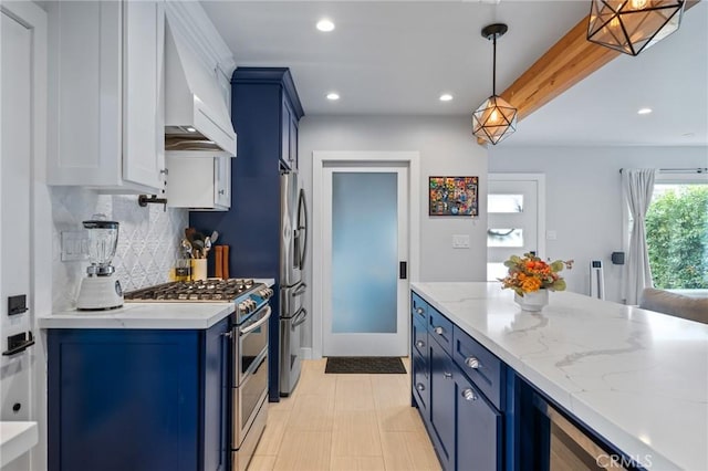 kitchen with stainless steel appliances, custom exhaust hood, light stone countertops, and blue cabinetry