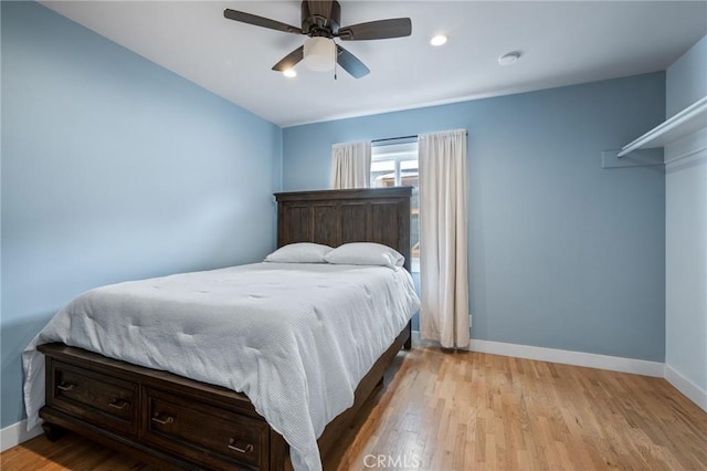 bedroom featuring ceiling fan and light hardwood / wood-style flooring