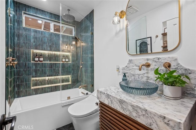 full bathroom with vanity, tiled shower / bath, backsplash, and toilet