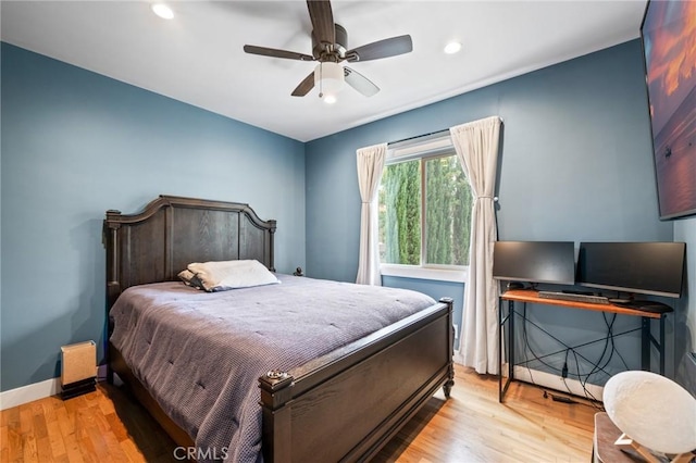 bedroom featuring light hardwood / wood-style floors and ceiling fan