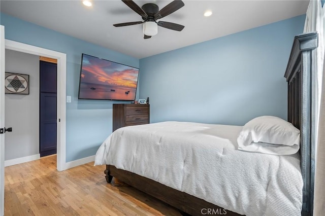 bedroom with light hardwood / wood-style floors and ceiling fan