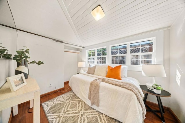 bedroom with lofted ceiling, hardwood / wood-style floors, and wooden ceiling