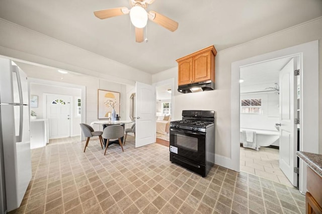 kitchen with white refrigerator, ceiling fan, black range with gas cooktop, and crown molding