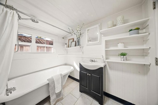 bathroom featuring a tub to relax in, wooden ceiling, ornamental molding, vanity, and tile patterned flooring