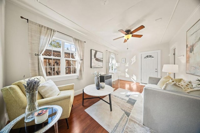 living room with wood-type flooring, ceiling fan, and plenty of natural light