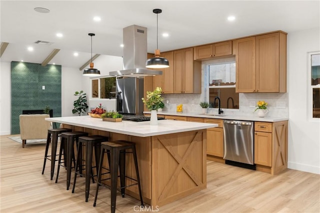 kitchen featuring sink, dishwasher, hanging light fixtures, a center island, and island exhaust hood