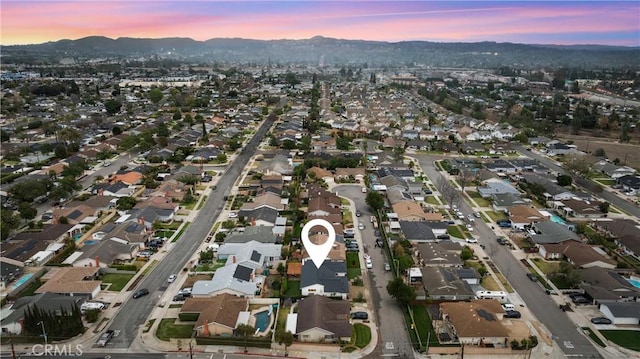 aerial view at dusk featuring a mountain view