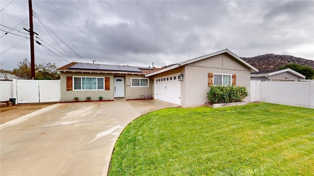 single story home featuring a garage, a front lawn, and solar panels