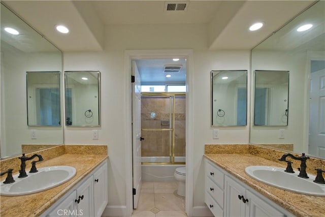 full bathroom featuring vanity, toilet, tile patterned flooring, and combined bath / shower with glass door