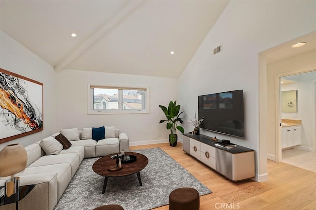 living room featuring high vaulted ceiling and light hardwood / wood-style flooring