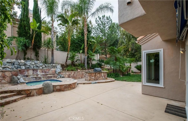 view of patio / terrace featuring an in ground hot tub