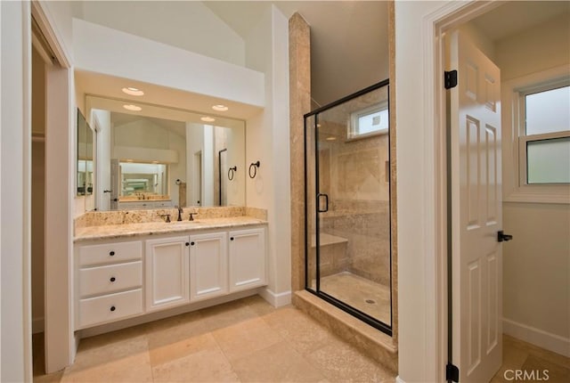 bathroom with vanity and a shower with shower door