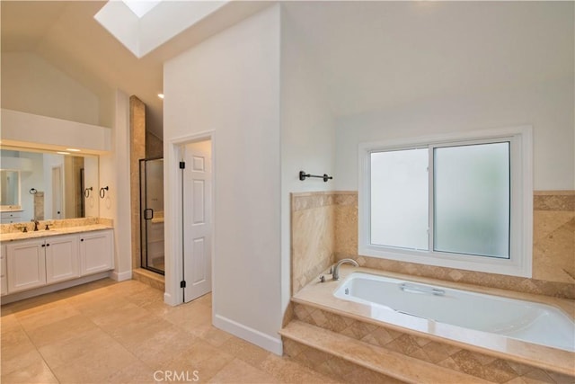 bathroom with vanity, vaulted ceiling with skylight, and separate shower and tub