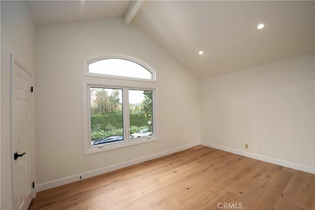 unfurnished room featuring beam ceiling, light hardwood / wood-style flooring, and a healthy amount of sunlight