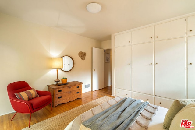 bedroom with a closet and light wood-type flooring