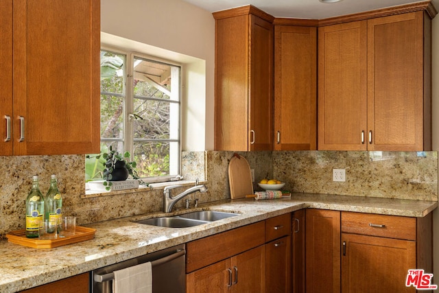 kitchen with tasteful backsplash, sink, stainless steel dishwasher, and light stone counters