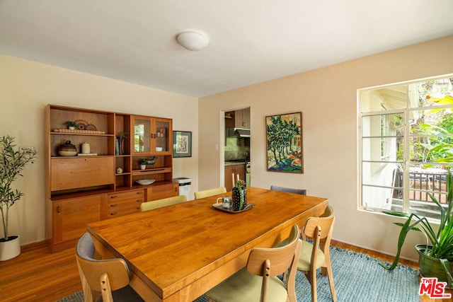 dining room with a healthy amount of sunlight and hardwood / wood-style floors