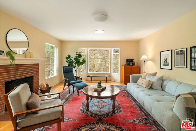 living room with a fireplace and light hardwood / wood-style flooring