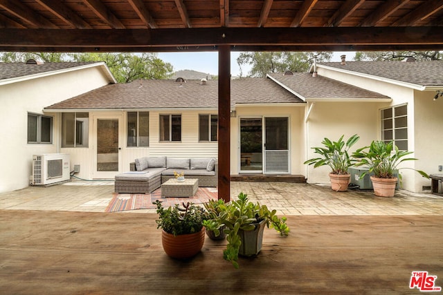 view of patio / terrace with an outdoor living space and ac unit