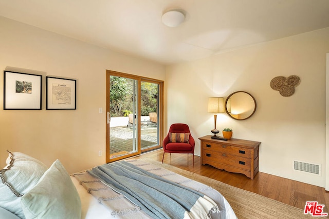 bedroom featuring hardwood / wood-style floors and access to outside