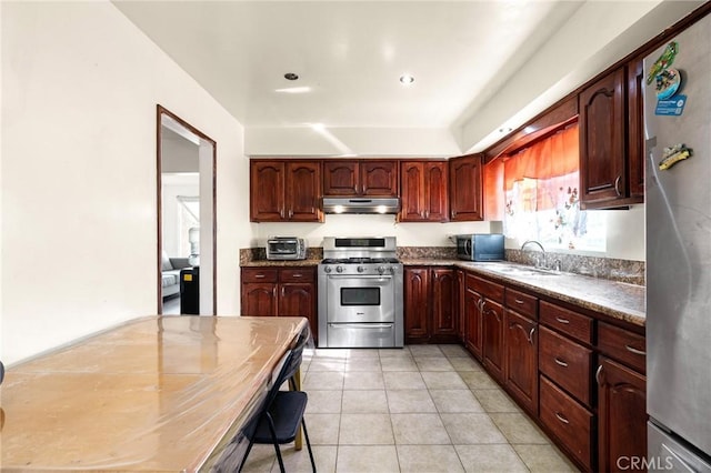 kitchen featuring stainless steel appliances, sink, and light tile patterned floors