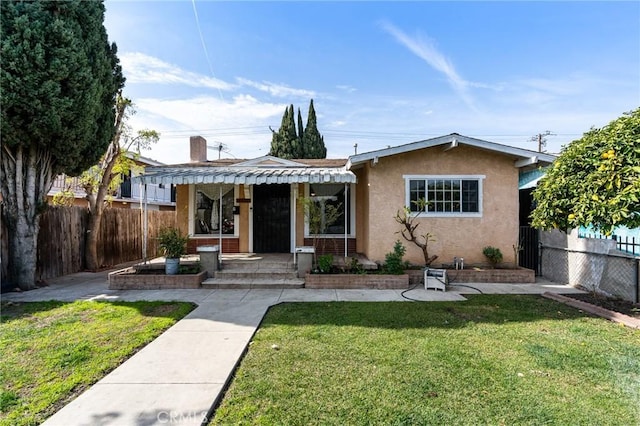 bungalow-style house with a front lawn