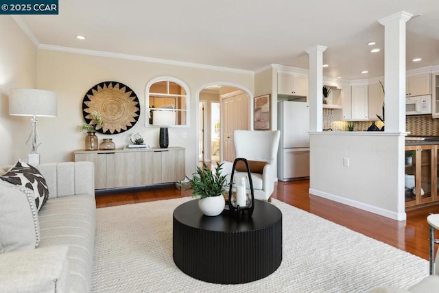 living room with ornamental molding, wood-type flooring, and decorative columns