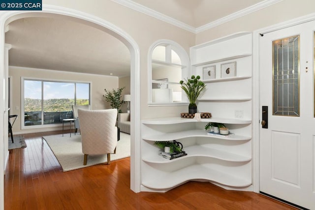 entrance foyer with crown molding and hardwood / wood-style floors