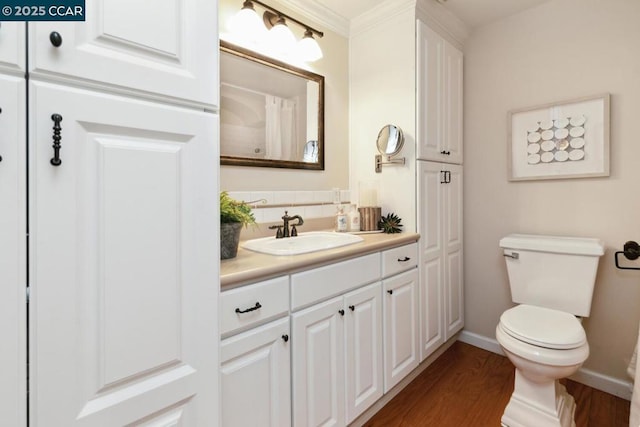 bathroom featuring vanity, toilet, and hardwood / wood-style floors